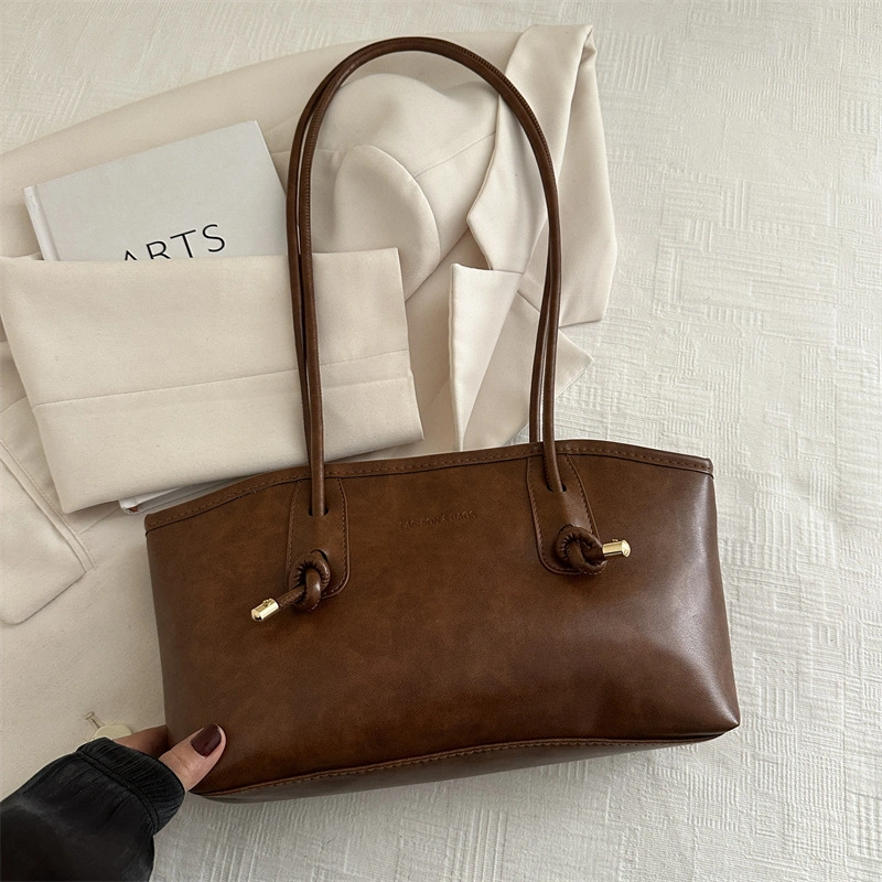 Q&N elongated brown shoulder bag with knotted handles